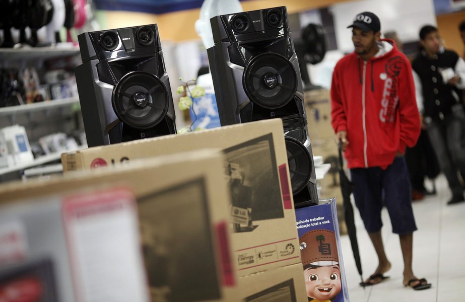 A man walks past speakers at a Casas Bahia store in Sao Paulo February 7, 2013. Brazil's inflation accelerated to the fastest rate in nearly eight years in January, raising bets of an interest rate hike this year that could complicate the government's dri (Foto: Gisele Federicce) A man walks past speakers at a Casas Bahia store in Sao Paulo February 7, 2013. Brazil's inflation accelerated to the fastest rate in nearly eight years in January, raising bets of an interest rate hike this year that could complicate the government's dri