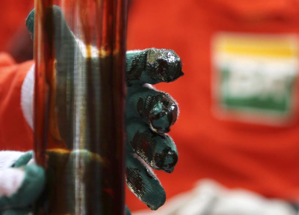 Operário checa amostra de petróleo na plataforma Cidade Angra dos Reis, no campo de Lula, a cerca de 300 km da costa do Rio de Janeiro. A Petrobras vai aumentar a produção neste ano com a operação de projetos atrasados e a entrada de plataformas previstas (Foto: Leonardo Attuch) Operário checa amostra de petróleo na plataforma Cidade Angra dos Reis, no campo de Lula, a cerca de 300 km da costa do Rio de Janeiro. A Petrobras vai aumentar a produção neste ano com a operação de projetos atrasados e a entrada de plataformas previstas