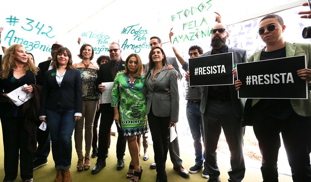 Artistas, lideranças indígenas e ambientalistas cobraram das presidências da Câmara e do Senado a revogação do decreto do governo Michel Temer que extingue a Reserva Nacional do Cobre e Associados (Renca); apesar do decreto ter sido suspenso diante da repercussão negativa da autorização para mineração em uma área da Amazônia de 45 mil quilômetros quadrados, um documento pela revogação da medida, contendo cerca de 1,5 milhão de assinaturas, foi entregues aos presidentes da Câmara e do Senado, Rodrigo Maia (DEM-RJ) e Eunício de Oliveira (PMDB-CE), respectivamente (Foto: Paulo Emílio) Artistas, lideranças indígenas e ambientalistas cobraram das presidências da Câmara e do Senado a revogação do decreto do governo Michel Temer que extingue a Reserva Nacional do Cobre e Associados (Renca); apesar do decreto ter sido suspenso diante da repercussão negativa da autorização para mineração em uma área da Amazônia de 45 mil quilômetros quadrados, um documento pela revogação da medida, contendo cerca de 1,5 milhão de assinaturas, foi entregues aos presidentes da Câmara e do Senado, Rodrigo Maia (DEM-RJ) e Eunício de Oliveira (PMDB-CE), respectivamente