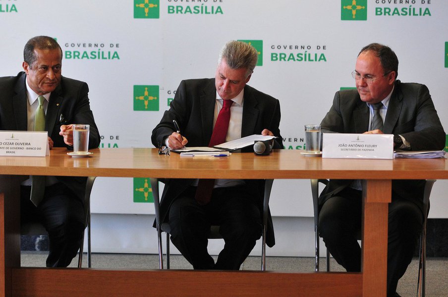 As reuniões do Fórum Permanente de Governadores começaram a apresentar resultados; no Palácio do Buriti, o governador do Distrito Federal, Rodrigo Rollemberg, assinou contrato de refinanciamento da dívida com a União, medida que resultará em economia de R$ 339,2 milhões aos cofres do Executivo; o montante será integralmente destinado à saúde pública; o total do passivo é R$ 1,3 bilhão; com a dedução, esse valor cairá para R$ 972 milhões; foto da esq. para a dir: vice-presidente de Governo do Banco do Brasil, Júlio Cezar Oliveira, governador Rodrigo Rollemberg, e secretário de Fazenda, João Antônio Fleury (Foto: Leonardo Lucena) As reuniões do Fórum Permanente de Governadores começaram a apresentar resultados; no Palácio do Buriti, o governador do Distrito Federal, Rodrigo Rollemberg, assinou contrato de refinanciamento da dívida com a União, medida que resultará em economia de R$ 339,2 milhões aos cofres do Executivo; o montante será integralmente destinado à saúde pública; o total do passivo é R$ 1,3 bilhão; com a dedução, esse valor cairá para R$ 972 milhões; foto da esq. para a dir: vice-presidente de Governo do Banco do Brasil, Júlio Cezar Oliveira, governador Rodrigo Rollemberg, e secretário de Fazenda, João Antônio Fleury