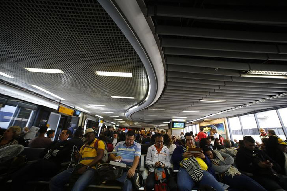 Passengers wait for their delayed flights at Alfonso Pena airport in Curitiba city, June 17, 2014. In a project called 'On The Sidelines' Reuters photographers share pictures showing their own quirky and creative view of the 2014 World Cup in Brazil. REUT (Foto: Gisele Federicce) Passengers wait for their delayed flights at Alfonso Pena airport in Curitiba city, June 17, 2014. In a project called 'On The Sidelines' Reuters photographers share pictures showing their own quirky and creative view of the 2014 World Cup in Brazil. REUT