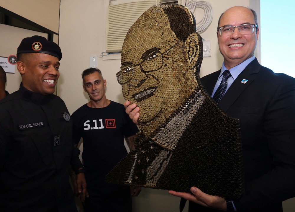 São profetas da morte, diz Manuela sobre pose de Witzel com quadro feito de balas São profetas da morte, diz Manuela sobre pose de Witzel com quadro feito de balas