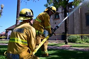 Firefighters try to extinguish a rooftop fire at San Gabriel Mission. Firefighters try to extinguish a rooftop fire at San Gabriel Mission.