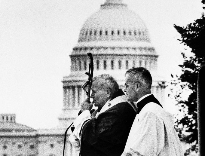 Pope John Paul II holds his crozier to his face during the Mass he celebrated on the Mall in Washington, D.C., on Oct. 7, 1979. At his side is Msgr. Virgilio Noe of the Vatican. Pope John Paul II holds his crozier to his face during the Mass he celebrated on the Mall in Washington, D.C., on Oct. 7, 1979. At his side is Msgr. Virgilio Noe of the Vatican.