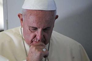 Pope Francis prays with journalists on the papal flight en route to South Korea on Aug. 14, 2014. Pope Francis prays with journalists on the papal flight en route to South Korea on Aug. 14, 2014.