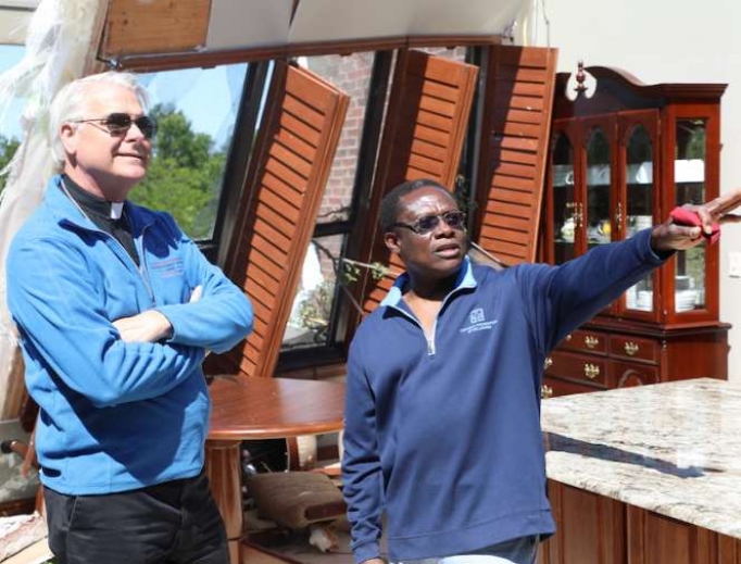 Archbishop Paul Coakley and Fr. Oby Zummas inspect damage at Holy Cross Catholic Church. Archbishop Paul Coakley and Fr. Oby Zummas inspect damage at Holy Cross Catholic Church.
