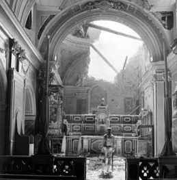 American soldier at altar in bombed Catholic Church in Acerno, Italy. Acerno was bombed in September 1943 by Anglo-American forces, which destroyed part of the bishop’s palace and the church of S. Maria degli Angeli. This was the scenario feared by civil and religious leaders in Assisi in 1943-44. American soldier at altar in bombed Catholic Church in Acerno, Italy. Acerno was bombed in September 1943 by Anglo-American forces, which destroyed part of the bishop’s palace and the church of S. Maria degli Angeli. This was the scenario feared by civil and religious leaders in Assisi in 1943-44.