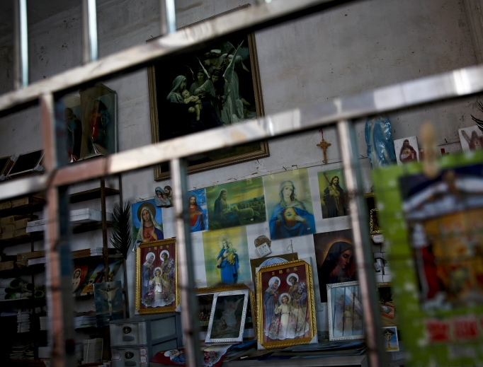 Catholic religious paintings and Bibles are displayed behind bars at an underground Catholic church in Jiexi county in south China's Guangdong province March 27. A group that monitors Christianity in China says the government is ratcheting up a crackdown on congregations in Beijing and several Chinese provinces, destroying crosses, burning Bibles and ordering followers to sign papers renouncing their faith. Churches have also been razed.
Catholic religious paintings and Bibles are displayed behind bars at an underground Catholic church in Jiexi county in south China's Guangdong province March 27. A group that monitors Christianity in China says the government is ratcheting up a crackdown on congregations in Beijing and several Chinese provinces, destroying crosses, burning Bibles and ordering followers to sign papers renouncing their faith. Churches have also been razed.
