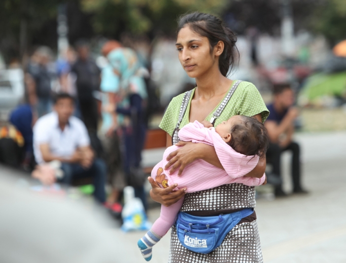 A young woman waits with her child by the train station in Belgrade, Serbia. A young woman waits with her child by the train station in Belgrade, Serbia.