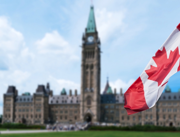 Canadian flag waving with Parliament Buildings in the background Ottawa,Ontario, Canada. Canadian flag waving with Parliament Buildings in the background Ottawa,Ontario, Canada.