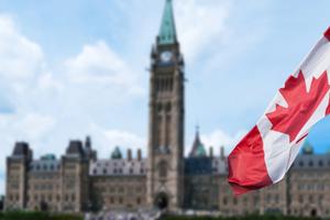 Canadian flag waving with Parliament Buildings in the background Ottawa,Ontario, Canada. Canadian flag waving with Parliament Buildings in the background Ottawa,Ontario, Canada.