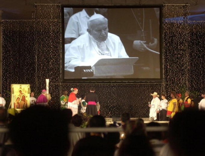 Hundreds of people attending an international Catholic conference on the role of the family listen to a broadcast of Pope John Paul II at a public park in the Philippine capital, Manila, Jan. 25, 2003, during the prayer vigil of the fourth World Meeting of Families. The meeting was called by Pope John Paul II to reaffirm the Christian family’s role in society. Hundreds of people attending an international Catholic conference on the role of the family listen to a broadcast of Pope John Paul II at a public park in the Philippine capital, Manila, Jan. 25, 2003, during the prayer vigil of the fourth World Meeting of Families. The meeting was called by Pope John Paul II to reaffirm the Christian family’s role in society.