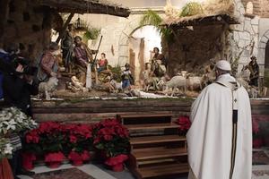 Pope Francis contemplates the Vatican Nativity scene. Pope Francis contemplates the Vatican Nativity scene.