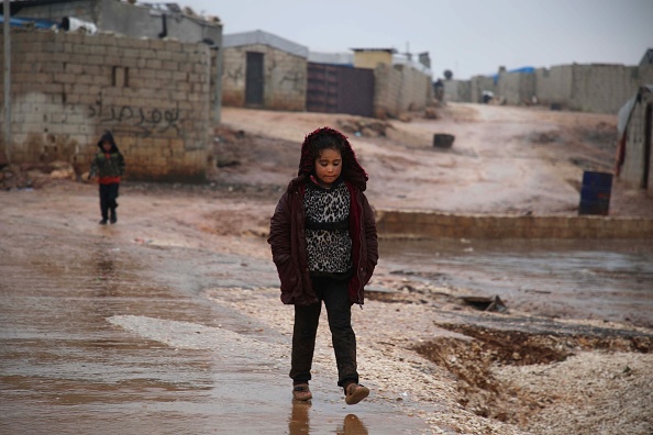 A Syrian girl walks in the mud near makeshift shelters following heavy rains, at a camp for displaced people in the village of Atme, in Syria's mostly rebel-held northern Idlib province Jan. 8. A Syrian girl walks in the mud near makeshift shelters following heavy rains, at a camp for displaced people in the village of Atme, in Syria's mostly rebel-held northern Idlib province Jan. 8.