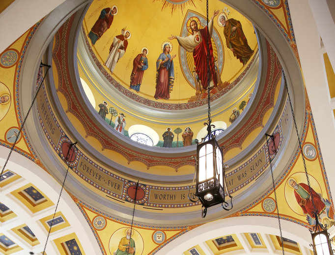 Above, the cathedral dome rises 144 feet into the air. Inside it are murals of the Sacred Heart flanked by Mary and St. Joseph, along with several other saints, ancient and modern. Below, the dedication Mass is underway. Above, the cathedral dome rises 144 feet into the air. Inside it are murals of the Sacred Heart flanked by Mary and St. Joseph, along with several other saints, ancient and modern. Below, the dedication Mass is underway.