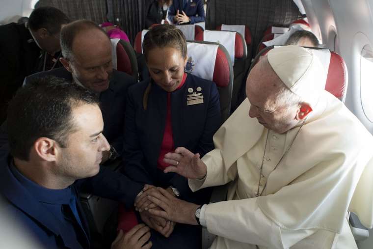Above, Pope Francis marries flight attendants Paula Podest and Carlos Ciuffardi during his flight from Santiago to Iquique, Chile, Jan. 18. Below: Podest and Ciuffardi. Also below, the marriage certificate was drawn up by cardinals who accompanied the Pope on the flight. Above, Pope Francis marries flight attendants Paula Podest and Carlos Ciuffardi during his flight from Santiago to Iquique, Chile, Jan. 18. Below: Podest and Ciuffardi. Also below, the marriage certificate was drawn up by cardinals who accompanied the Pope on the flight.