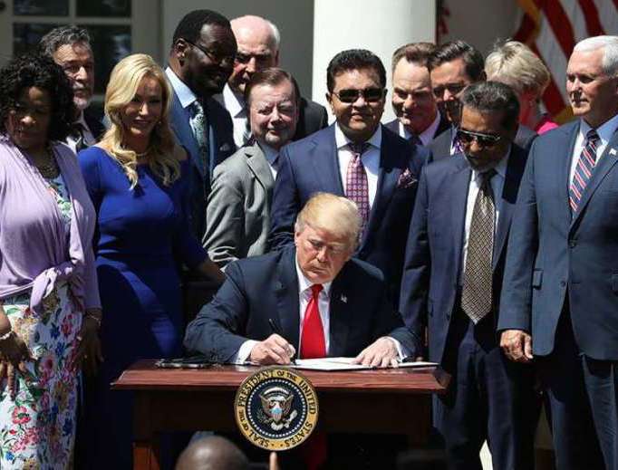 President Donald Trump signs a proclamation at the National Day of Prayer event held in the Rose Garden on May 3, 2018.
President Donald Trump signs a proclamation at the National Day of Prayer event held in the Rose Garden on May 3, 2018.