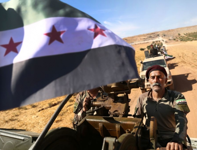 Turkish-backed Syrian rebel fighters head to an area near the Syrian-Turkish border north of Aleppo on Oct. 8. U.S. forces in northern Syria started pulling back from areas along the Turkish border ahead of the Turkish invasion.
Turkish-backed Syrian rebel fighters head to an area near the Syrian-Turkish border north of Aleppo on Oct. 8. U.S. forces in northern Syria started pulling back from areas along the Turkish border ahead of the Turkish invasion.