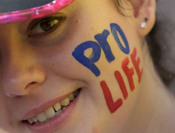 Young woman takes part in a pro-life rally in Ireland. Young woman takes part in a pro-life rally in Ireland.
