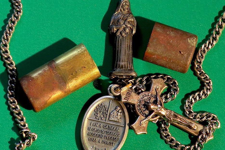 A pocket shrine, a holy medal, and a St. Benedict crucifix. A pocket shrine, a holy medal, and a St. Benedict crucifix.