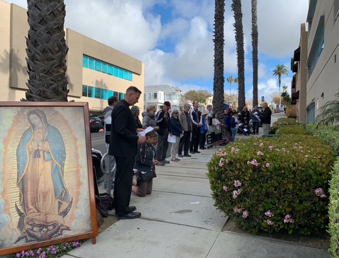 Above, Bishop Joseph Coffey prays the Rosary in front of a Planned Parenthood center in San Diego. Above, Bishop Joseph Coffey prays the Rosary in front of a Planned Parenthood center in San Diego.