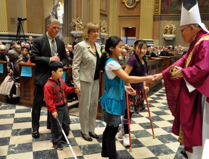 Archbishop Charles Chaput greets gift-bearers at a Mass for persons with disabilities and the deaf community. Archbishop Charles Chaput greets gift-bearers at a Mass for persons with disabilities and the deaf community.