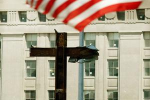 An American flag flies above the cross of steel beams discovered in the rubble at Ground Zero on Aug. 19, 2002, in New York City. An American flag flies above the cross of steel beams discovered in the rubble at Ground Zero on Aug. 19, 2002, in New York City.