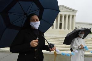 Little Sisters of the Poor convened in front of the United States Supreme Court wearing masks to pray the Rosary before the historic telephonic oral arguments. Little Sisters of the Poor convened in front of the United States Supreme Court wearing masks to pray the Rosary before the historic telephonic oral arguments.
