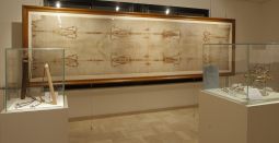 A life-size reproduction of the Shroud of Turin is seen in a permanent exhibit at Regina Apostolorum University in Rome Jan. 21. At left are examples of Roman whips for scourging; at right is a crown of thorns. Although the Shroud of Turin has been studied from virtually every scientific angle, no one has been able to fully explain how the image was transferred to the linen cloth. A life-size reproduction of the Shroud of Turin is seen in a permanent exhibit at Regina Apostolorum University in Rome Jan. 21. At left are examples of Roman whips for scourging; at right is a crown of thorns. Although the Shroud of Turin has been studied from virtually every scientific angle, no one has been able to fully explain how the image was transferred to the linen cloth.