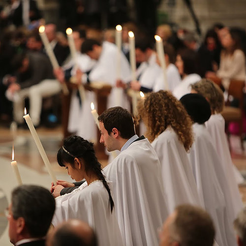 WELCOME HOME! Catechumens receive candles at the Easter vigil Mass before receiving the sacraments in St. Peter's Basilica.
WELCOME HOME! Catechumens receive candles at the Easter vigil Mass before receiving the sacraments in St. Peter's Basilica.