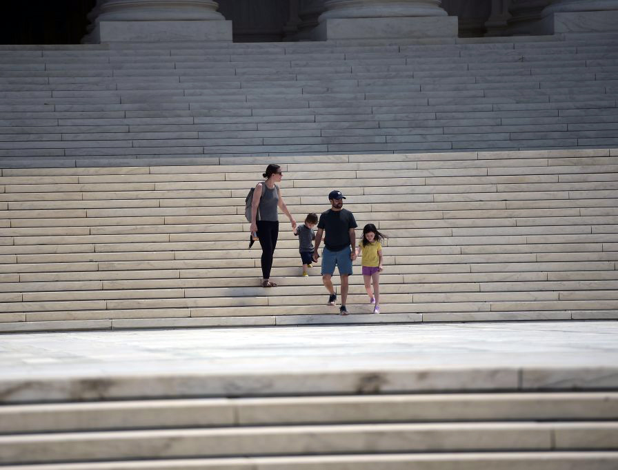 A family walks down the steps of the U.S. Supreme Court building in Washington, D.C., on Monday.
A family walks down the steps of the U.S. Supreme Court building in Washington, D.C., on Monday.