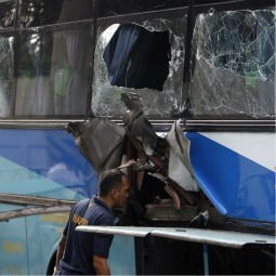 A member of a forensic team examines damage on a passenger bus after an explosion along a major road in Manila, Philippines, Jan. 25. The blast killed five people and wounded 12 others, reported the Asian Church news agency UCA News. A member of a forensic team examines damage on a passenger bus after an explosion along a major road in Manila, Philippines, Jan. 25. The blast killed five people and wounded 12 others, reported the Asian Church news agency UCA News.