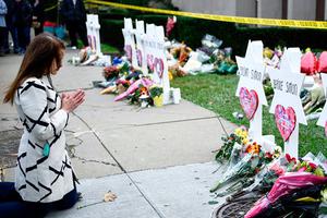 People pay their respects Oct. 29 at a memorial outside the Tree of Life synagogue after a shooting there left 11 people dead in the Squirrel Hill neighborhood of Pittsburgh, Pennsylvania, on Saturday.
People pay their respects Oct. 29 at a memorial outside the Tree of Life synagogue after a shooting there left 11 people dead in the Squirrel Hill neighborhood of Pittsburgh, Pennsylvania, on Saturday.