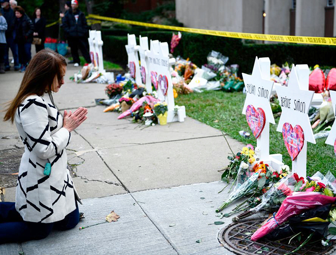 People pay their respects Oct. 29 at a memorial outside the Tree of Life synagogue after a shooting there left 11 people dead in the Squirrel Hill neighborhood of Pittsburgh, Pennsylvania, on Saturday.
People pay their respects Oct. 29 at a memorial outside the Tree of Life synagogue after a shooting there left 11 people dead in the Squirrel Hill neighborhood of Pittsburgh, Pennsylvania, on Saturday.