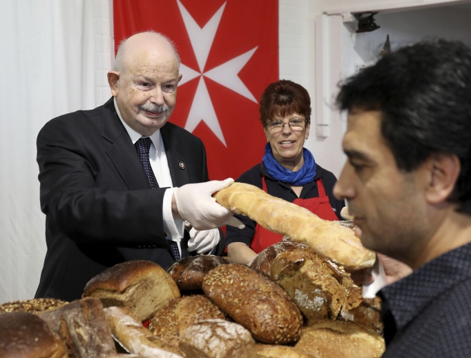 Fra’ Giacomo Dalla Torre del Tempio di Sanguinetto (l), the most recent grand master of the Order of Malta, distributes bread on Oct. 15, 2019, in North Rhine-Westphalia, Pulheim, Germany. Fra’ Giacomo Dalla Torre del Tempio di Sanguinetto (l), the most recent grand master of the Order of Malta, distributes bread on Oct. 15, 2019, in North Rhine-Westphalia, Pulheim, Germany.