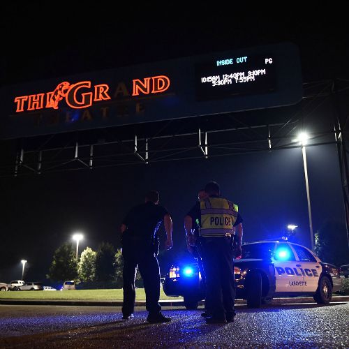 Police stand outside of the Grand Theater on July 23 in Lafayette, La., following a mass shooting that left three people dead and more injured. Police stand outside of the Grand Theater on July 23 in Lafayette, La., following a mass shooting that left three people dead and more injured.