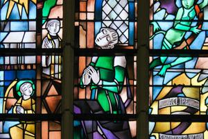 Stained glass image of penitent on a Catholic church in Belgium. Stained glass image of penitent on a Catholic church in Belgium.