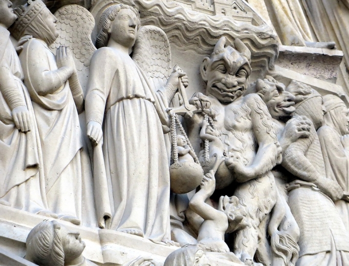 Relief of St. Michael vs. the devil at Notre Dame Cathedral in Paris. Relief of St. Michael vs. the devil at Notre Dame Cathedral in Paris.