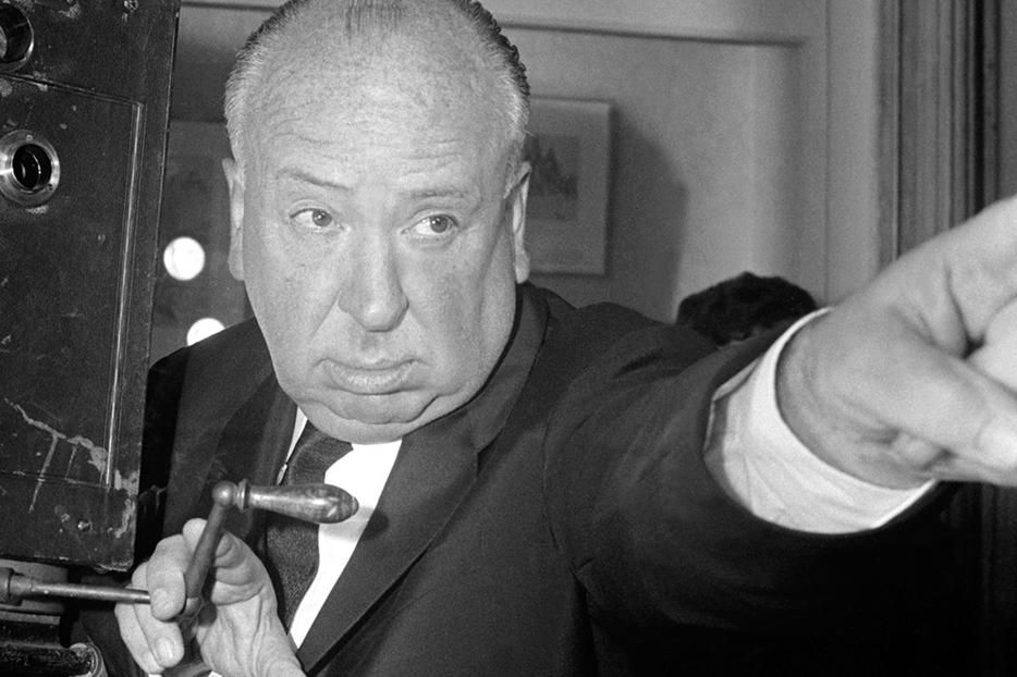 British film director Alfred Hitchcock stands next to an old cinematograph (film camera) at the Cinémathèque Française in Paris, France, on May 28, 1960. British film director Alfred Hitchcock stands next to an old cinematograph (film camera) at the Cinémathèque Française in Paris, France, on May 28, 1960.