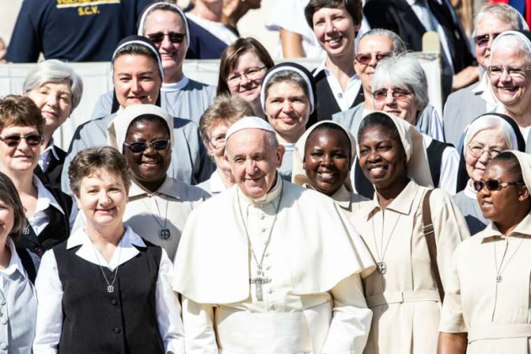 Pope Francis smiles with sisters at his general audience Sept. 11. Pope Francis smiles with sisters at his general audience Sept. 11.
