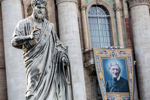 A banner with the official image of St. John Henry Newman hangs on the facade of St. Peter’s Basilica Oct. 10, before his canonization on Oct. 13. A banner with the official image of St. John Henry Newman hangs on the facade of St. Peter’s Basilica Oct. 10, before his canonization on Oct. 13.