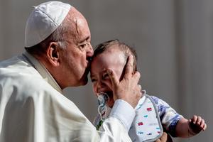 Pope Francis kisses an infant on the forehead during his weekly General Audience, 2019. Pope Francis kisses an infant on the forehead during his weekly General Audience, 2019.