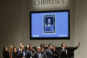 Agents speak on their phones with their clients while bidding at the auction of Leonardo da Vinci's 'Salvator Mundi' (shown below) during the Post-War and Contemporary Art evening sale at Christie's on Nov. 15 in New York City. The rediscovered masterpiece by the Renaissance master sold for a historic $450,312,500, obliterating the previous world record for the most expensive work of art at auction. Agents speak on their phones with their clients while bidding at the auction of Leonardo da Vinci's 'Salvator Mundi' (shown below) during the Post-War and Contemporary Art evening sale at Christie's on Nov. 15 in New York City. The rediscovered masterpiece by the Renaissance master sold for a historic $450,312,500, obliterating the previous world record for the most expensive work of art at auction.