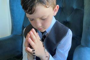 Fletcher Abner with his first Communion rosary. The rosary he is holding was made by his grandmother, Shirley Jones. She has made more than 20 for her grandchildren on their first Communion. Fletcher Abner with his first Communion rosary. The rosary he is holding was made by his grandmother, Shirley Jones. She has made more than 20 for her grandchildren on their first Communion.
