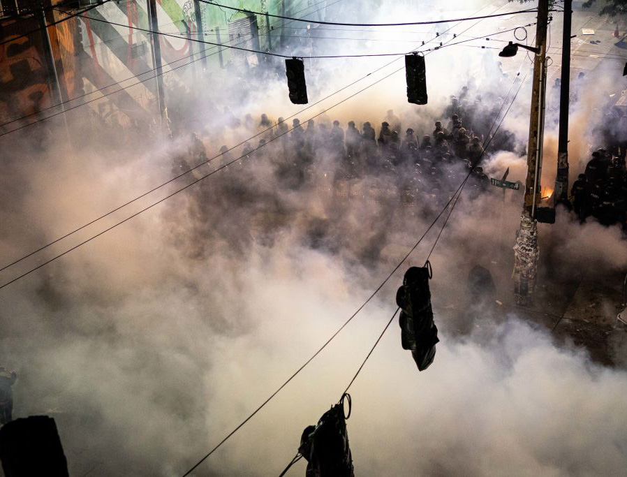Tear gas fills the air as demonstrators clash with police near the Seattle Police Department’s East Precinct on June 8. Tear gas fills the air as demonstrators clash with police near the Seattle Police Department’s East Precinct on June 8.
