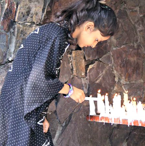 A young girl lights a candle at a Marian grotto in Pakistan.
A young girl lights a candle at a Marian grotto in Pakistan.