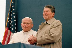 President Ronald Reagan smiles at the crowd as Pope John Paul II stands by his side during a joint appearance at the airport in Fairbanks, Alaska, May 2, 1984. President Ronald Reagan smiles at the crowd as Pope John Paul II stands by his side during a joint appearance at the airport in Fairbanks, Alaska, May 2, 1984.