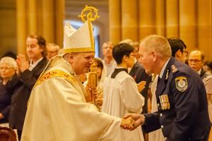 Above, Archbishop Anthony Fisher greets New South Wales Police Commissioner Mick Fuller at a Jan. 12 Mass to pray for all those affected by the bushfires. Below, an estimated 800 people attended the funeral Mass for fallen firefighter Andrew O’Dwyer, including his 19-month-old daughter, Charlotte. O’Dwyer died amid the fire-fighting. Above, Archbishop Anthony Fisher greets New South Wales Police Commissioner Mick Fuller at a Jan. 12 Mass to pray for all those affected by the bushfires. Below, an estimated 800 people attended the funeral Mass for fallen firefighter Andrew O’Dwyer, including his 19-month-old daughter, Charlotte. O’Dwyer died amid the fire-fighting.