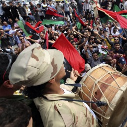 Libyans celebrate at Martyrs square in Tripoli Oct. 20 after hearing the news that Libyan leader Moammar Gadhafi was killed in Sirte. Libyans celebrate at Martyrs square in Tripoli Oct. 20 after hearing the news that Libyan leader Moammar Gadhafi was killed in Sirte.