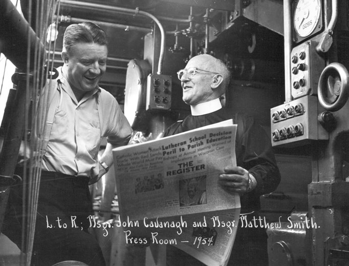 Msgr. Matthew Smith discusses a new issue of the National Catholic Register with Msgr. John Cavanaugh in the press room in Denver. Msgr. Matthew Smith discusses a new issue of the National Catholic Register with Msgr. John Cavanaugh in the press room in Denver.